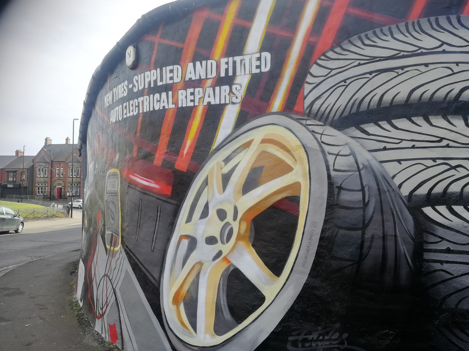 The hand-painted mural on the Sunderland Auto Electrics workshop — an alloy wheel and the words Auto Electrical Repairs